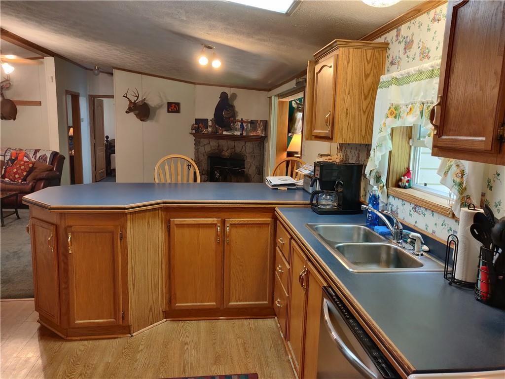 6173 Philadelphia Road Springboro, PA 16435 - Photo 11 of 25 a kitchen with stainless steel appliances granite countertop a sink stove and refrigerator