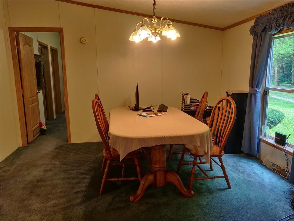 6173 Philadelphia Road Springboro, PA 16435 - Photo 12 of 25 a view of a dining room with furniture and a chandelier