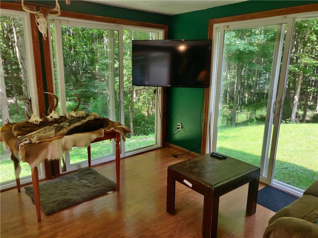 6173 Philadelphia Road Springboro, PA 16435 - Photo 15 of 25 a living room with pool table and a floor to ceiling window