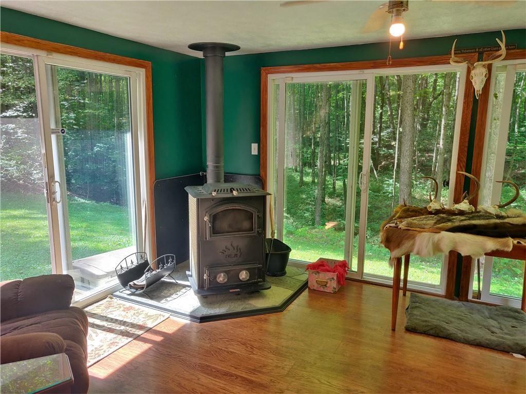 6173 Philadelphia Road Springboro, PA 16435 - Photo 17 of 25 a living room with fireplace furniture and a large window