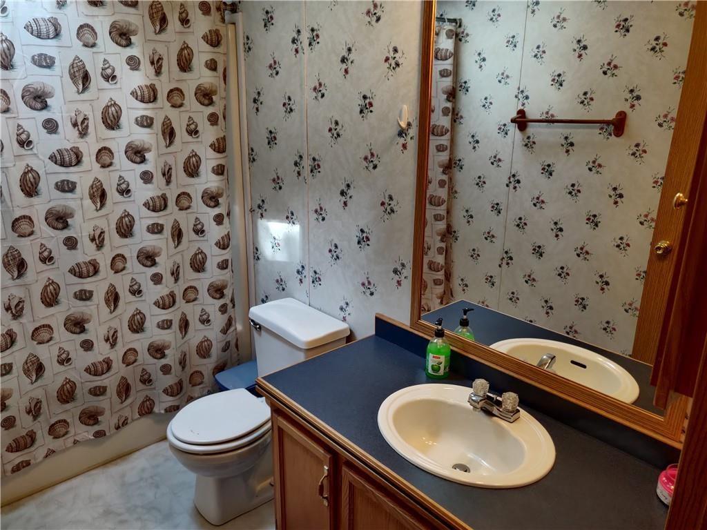 6173 Philadelphia Road Springboro, PA 16435 - Photo 18 of 25 a bathroom with a sink toilet and mirror