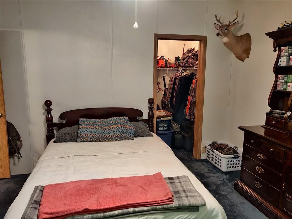6173 Philadelphia Road Springboro, PA 16435 - Photo 19 of 25 a bedroom with a bed and a mirror