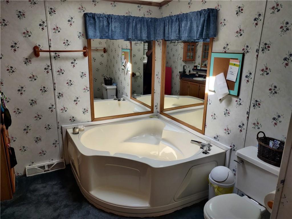 6173 Philadelphia Road Springboro, PA 16435 - Photo 20 of 25 a bathroom with a tub sink and toilet