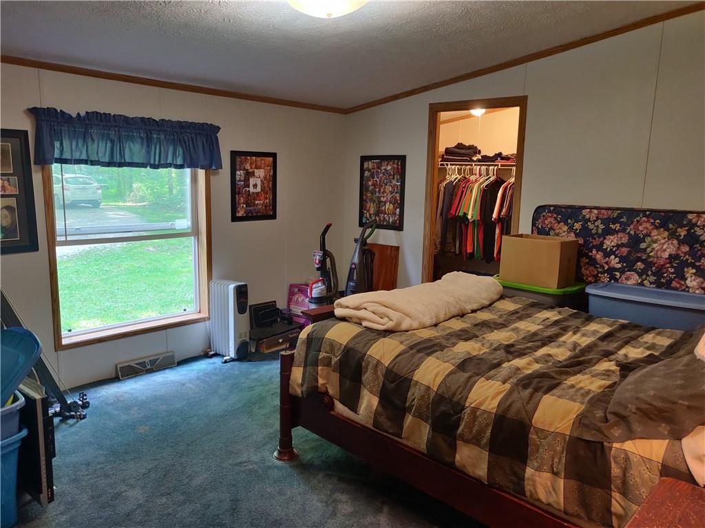 6173 Philadelphia Road Springboro, PA 16435 - Photo 21 of 25 a bedroom with a bed and a window