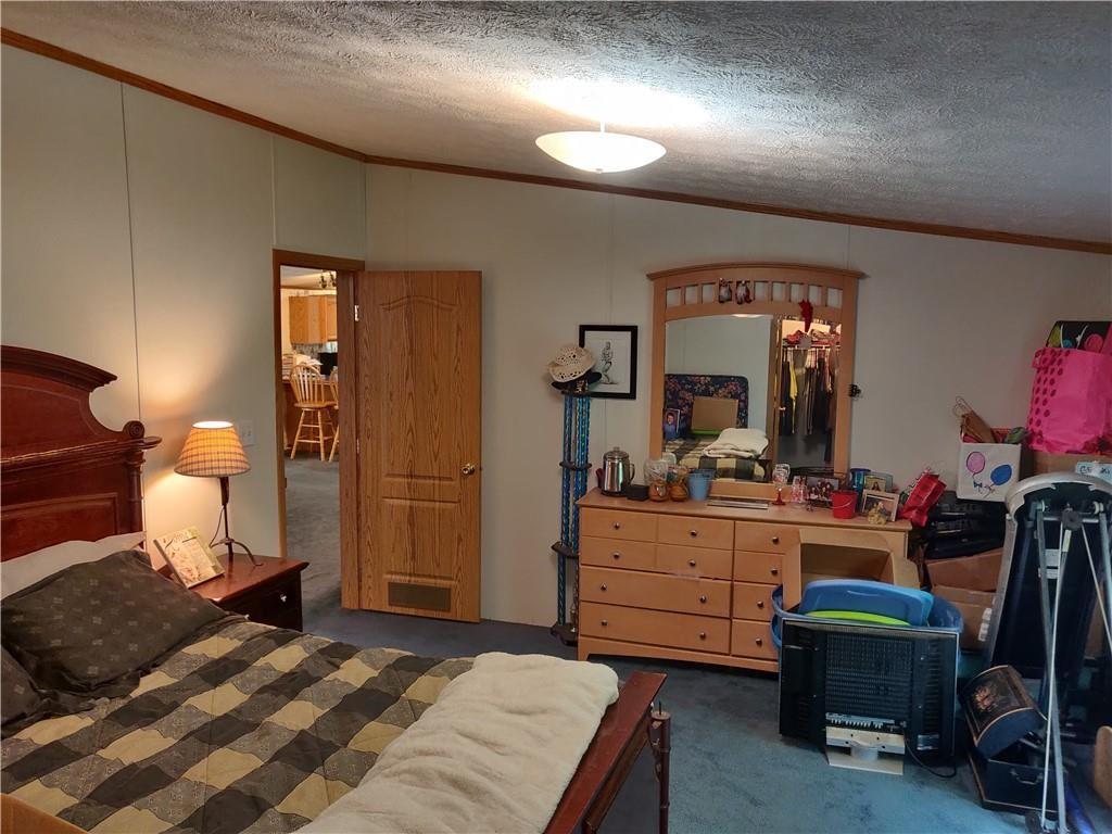 6173 Philadelphia Road Springboro, PA 16435 - Photo 22 of 25 a bedroom with a bed and a dresser