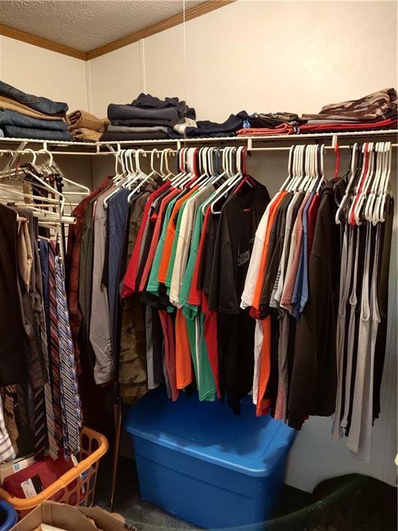 6173 Philadelphia Road Springboro, PA 16435 - Photo 23 of 25 a view of walk in closet with clothes and shoes