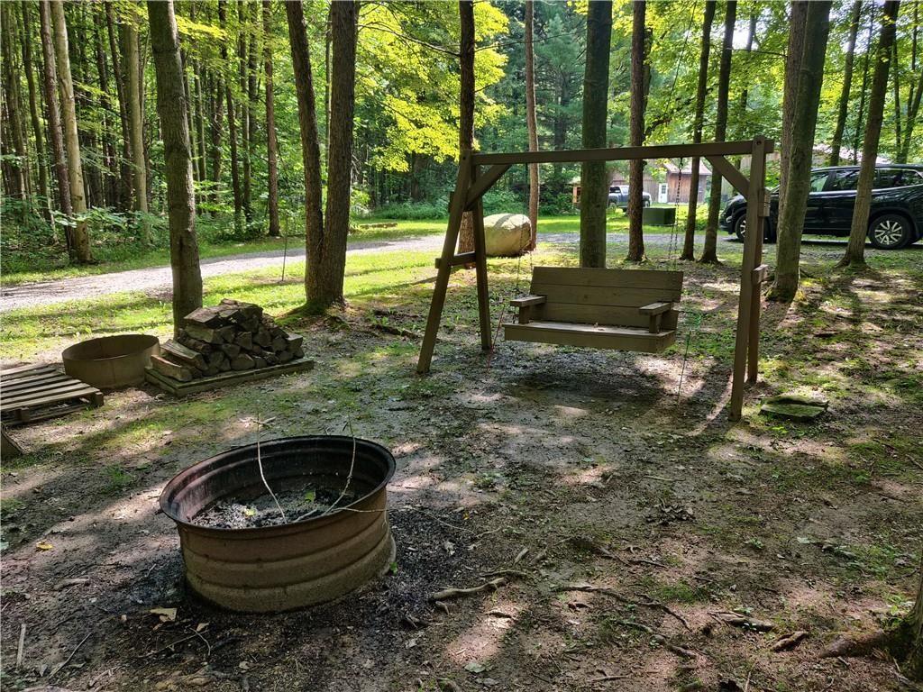 6173 Philadelphia Road Springboro, PA 16435 - Photo 4 of 25 a backyard of a house with barbeque oven fire pit table and chairs