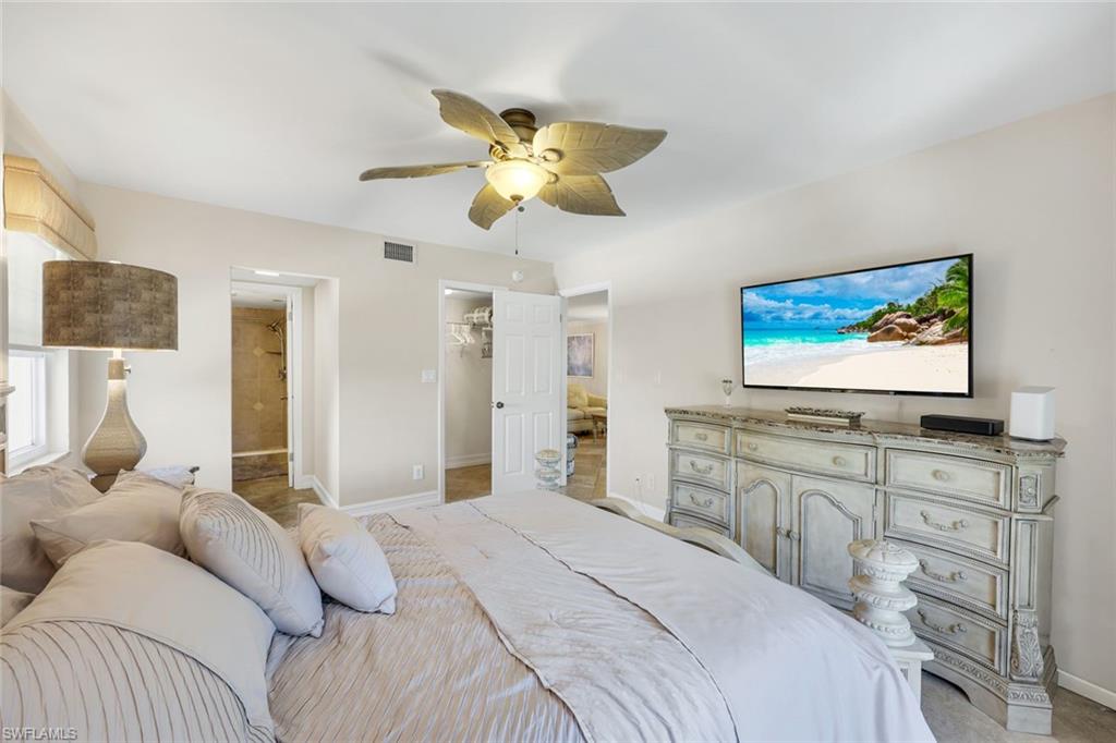 4200 Belair Lane, Unit 316 Naples, FL 34103 - Photo 11 of 18 a bedroom with a bed and furniture
