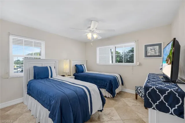 a bedroom with double bed and a window