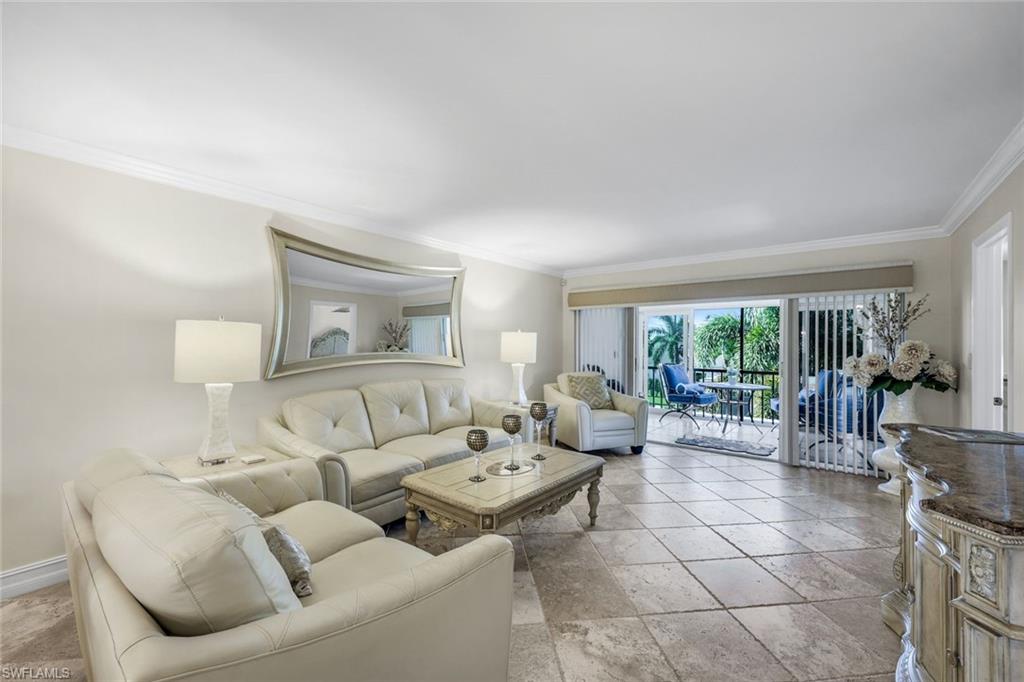 4200 Belair Lane, Unit 316 Naples, FL 34103 - Photo 6 of 18 a living room with furniture and a large window