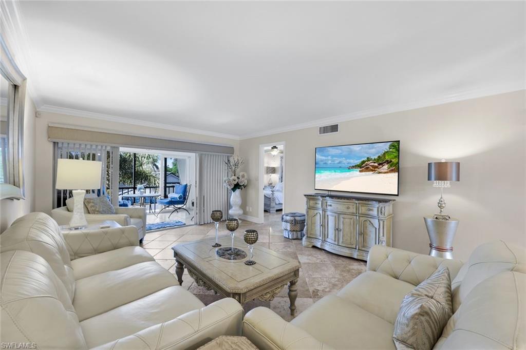 4200 Belair Lane, Unit 316 Naples, FL 34103 - Photo 7 of 18 a living room with furniture and a flat screen tv