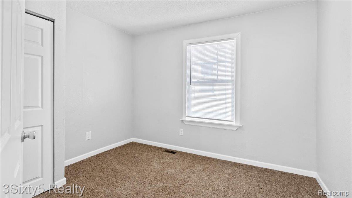 202 Haltiner Street River Rouge, MI 48218 - Photo 11 of 19 Empty room with dark colored carpet and a textured ceiling