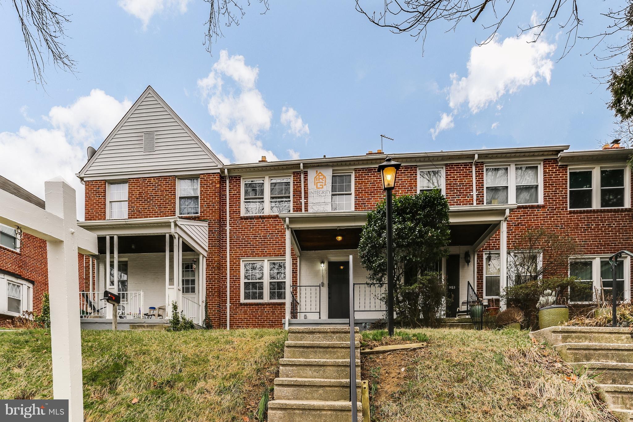 1425 Kitmore Road Baltimore, MD 21239 - Photo 1 of 23 a front view of a house with a yard