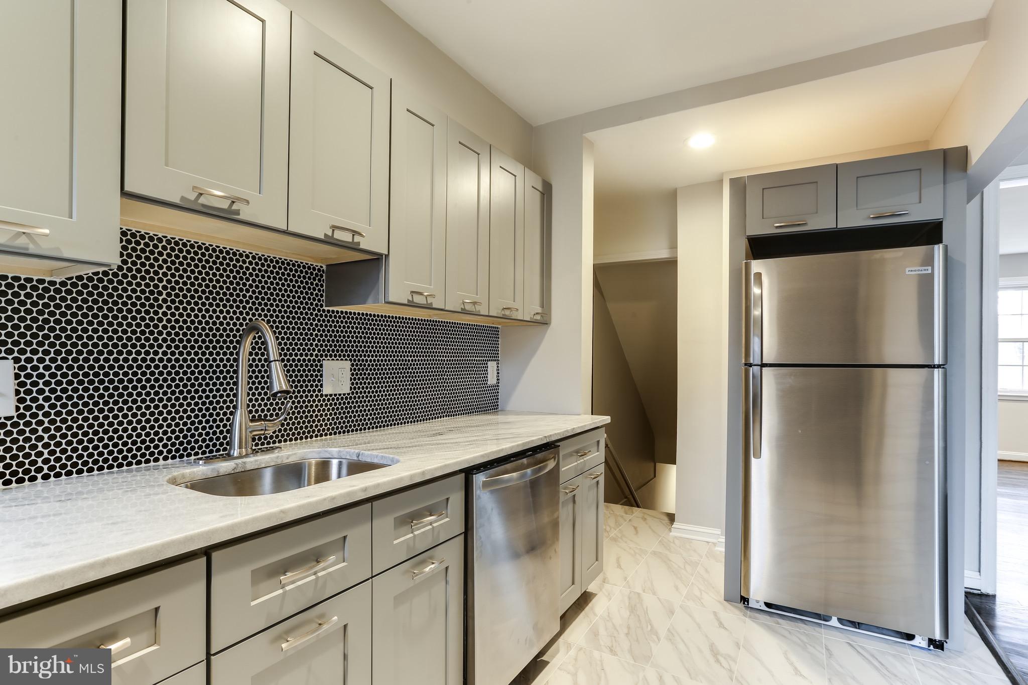 1425 Kitmore Road Baltimore, MD 21239 - Photo 3 of 23 a kitchen with stainless steel appliances granite countertop a refrigerator a sink and white cabinets