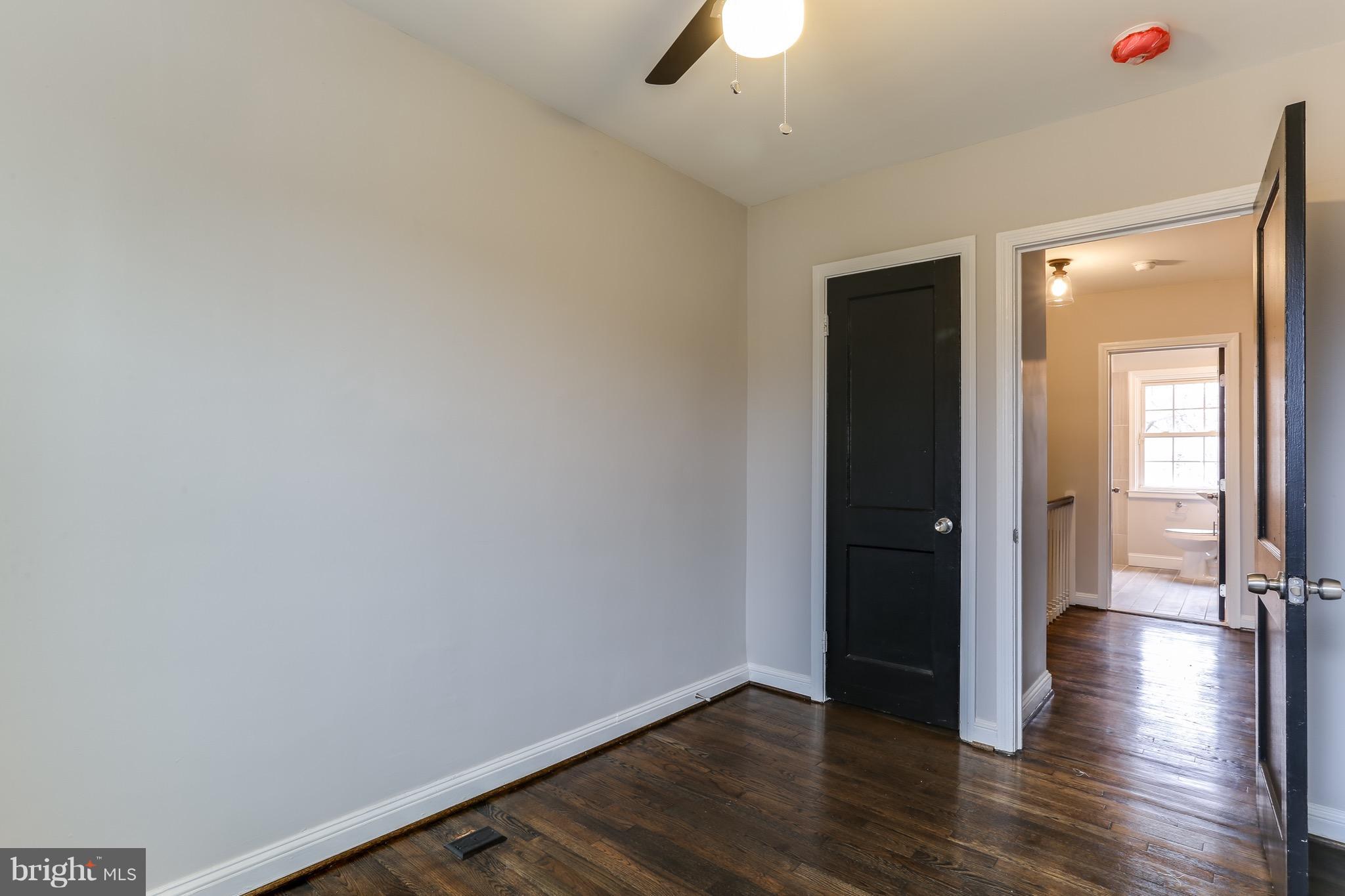 1425 Kitmore Road Baltimore, MD 21239 - Photo 5 of 23 a view of an empty room with wooden floor