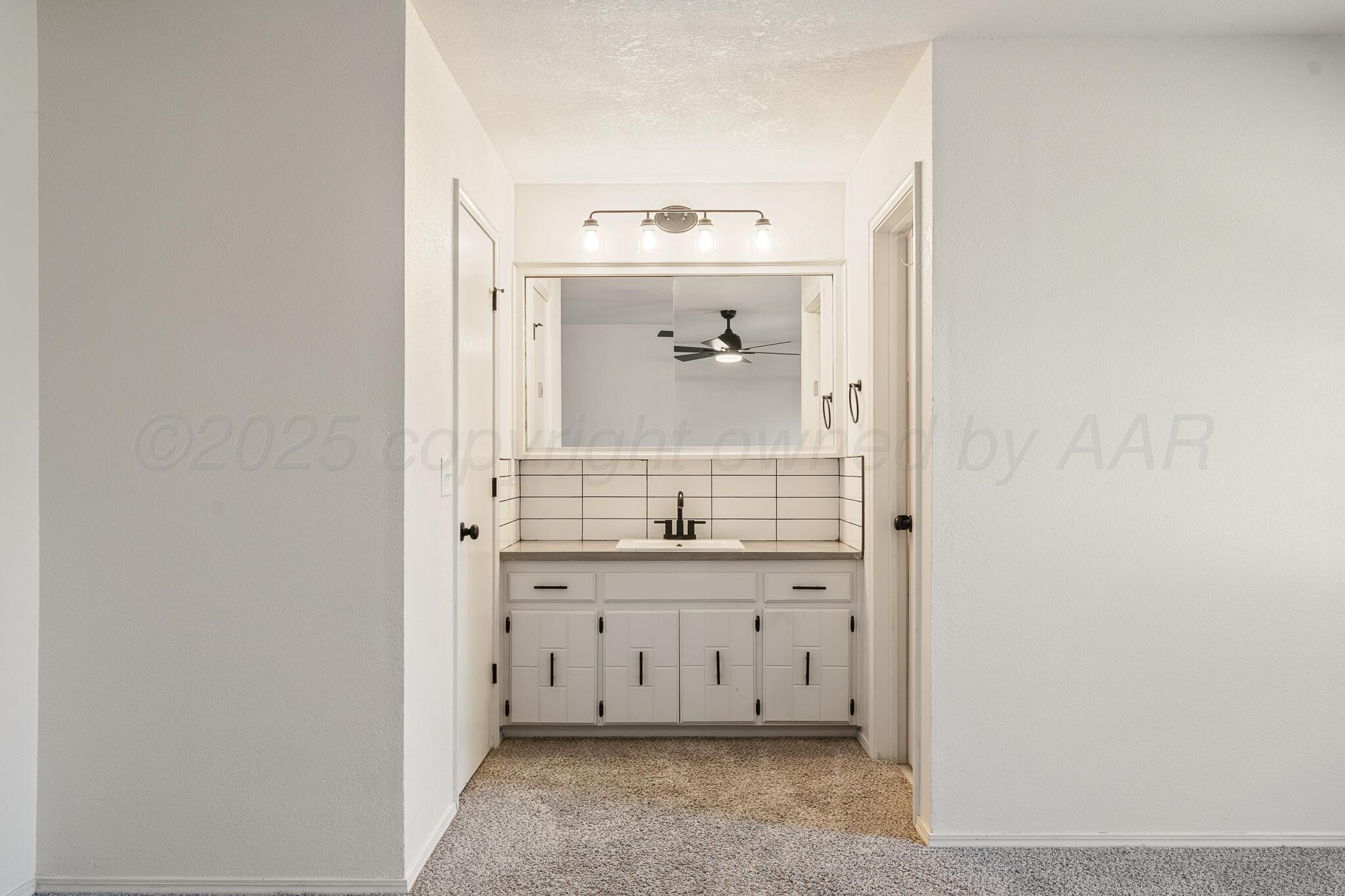 6212 Rutgers Street Amarillo, TX 79109 - Photo 13 of 26 a bathroom with a sink and a mirror