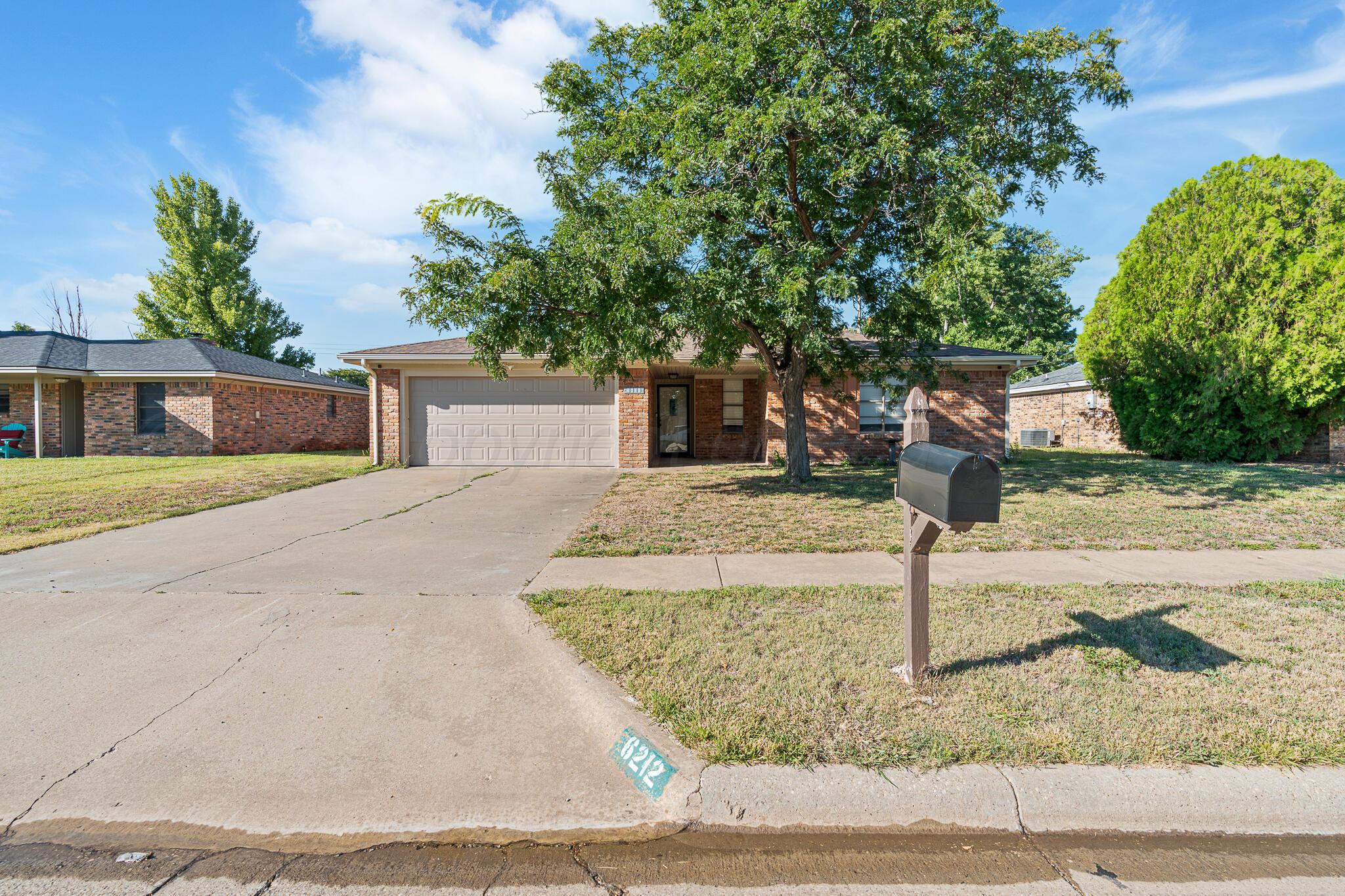 6212 Rutgers Street Amarillo, TX 79109 - Photo 2 of 26 a front view of a house with garden