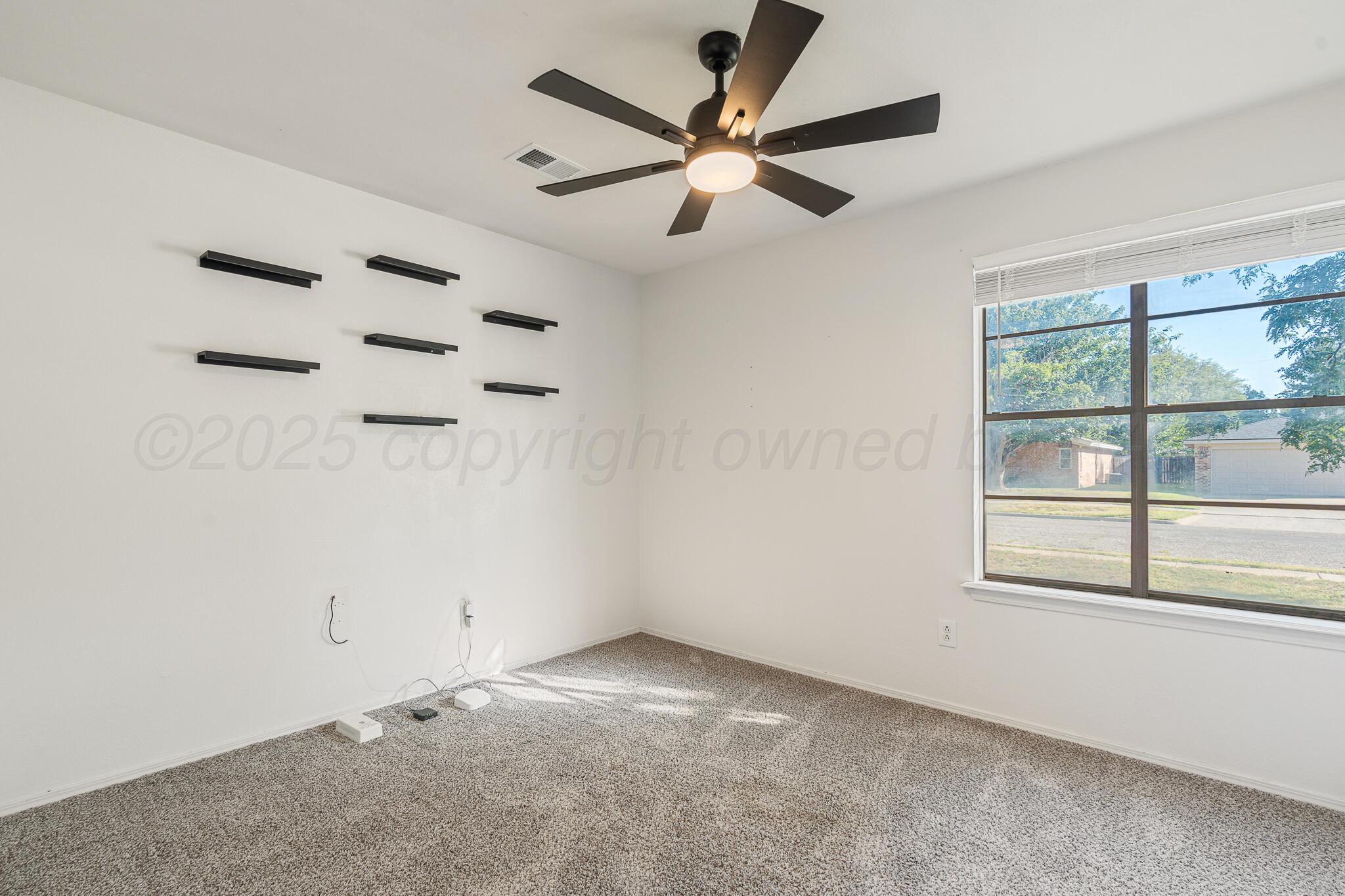 6212 Rutgers Street Amarillo, TX 79109 - Photo 22 of 26 an empty room with a window and a fan