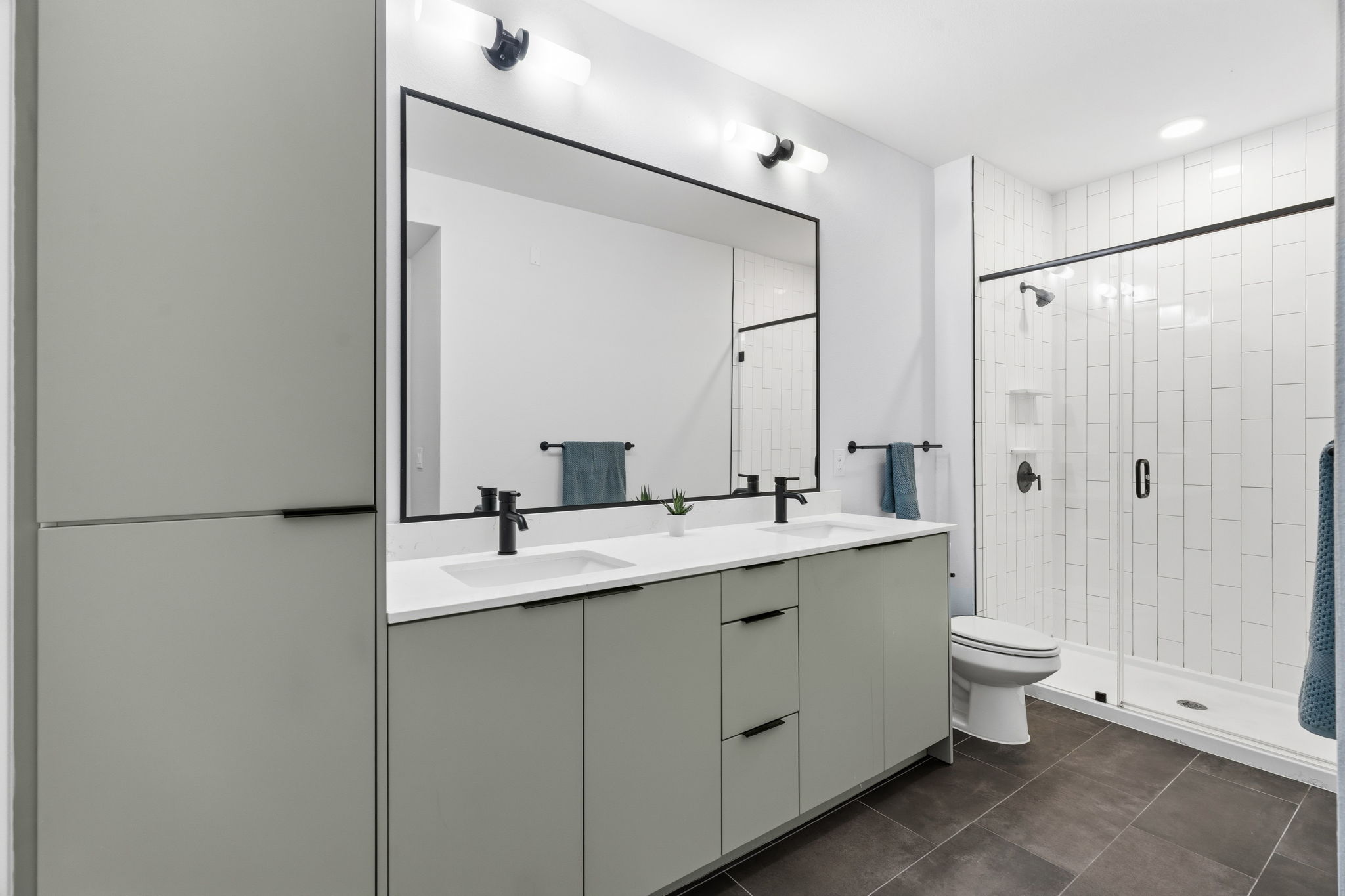2500 Longview Street, Unit 116 Austin, TX 78705 - Photo 8 of 27 Large primary bathroom featuring a double vanity with light gray cabinetry, a large framed mirror, and a walk-in shower.