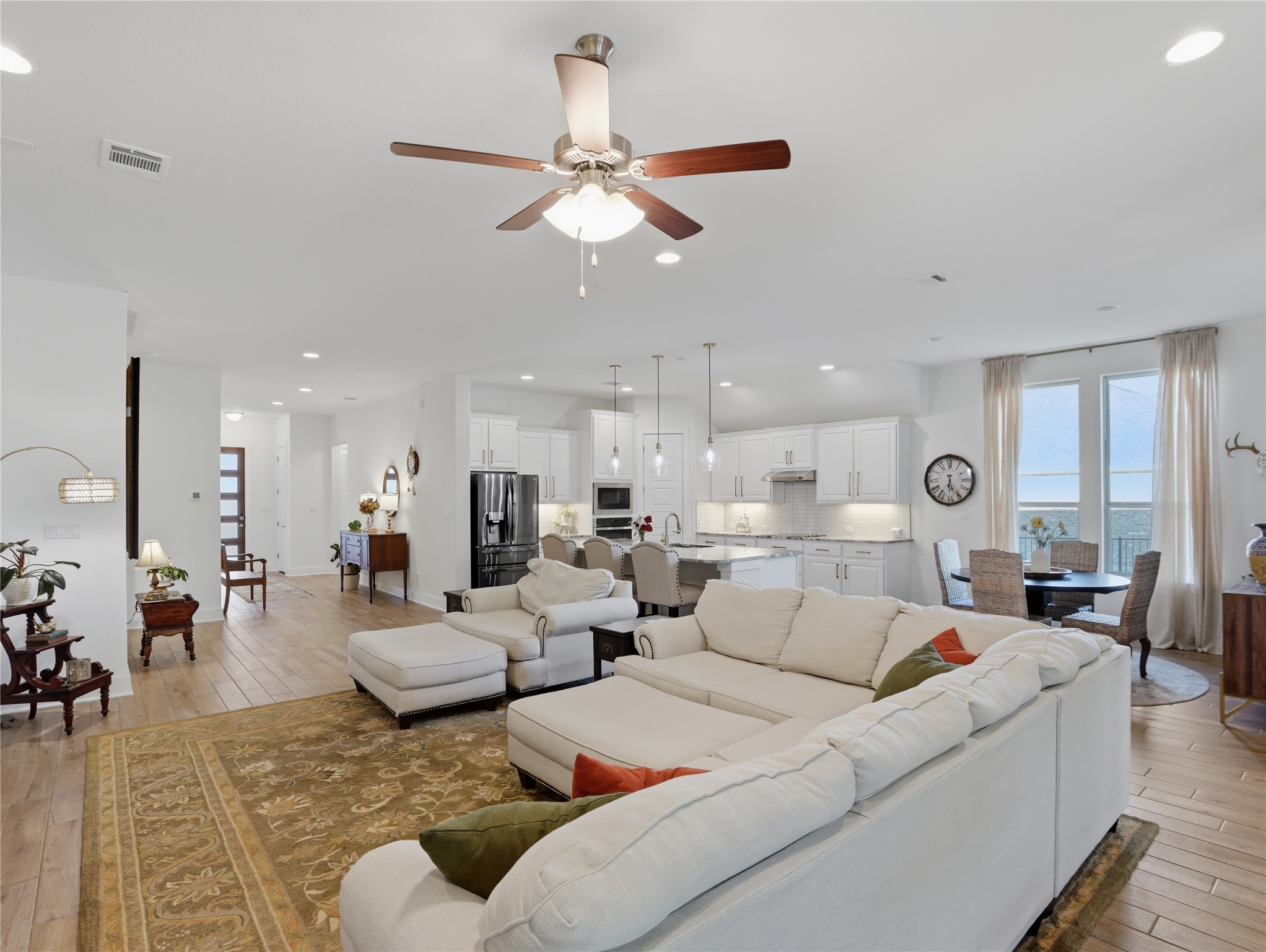 316 Raptor Beak Way Cedar Creek, TX 78612 - Photo 7 of 30 a living room with furniture kitchen view and a chandelier
