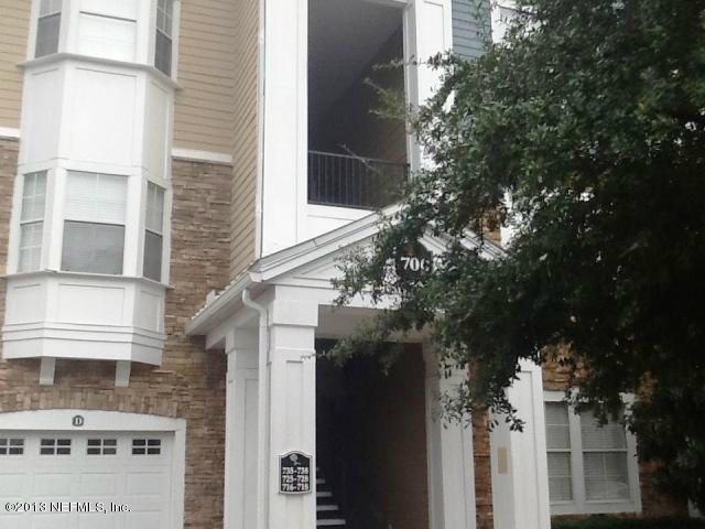 a view of a buildings with a tree