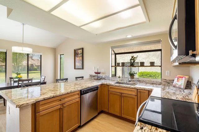 a kitchen with a sink stove and cabinets