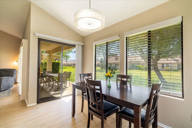 a dining room with furniture window and wooden floor