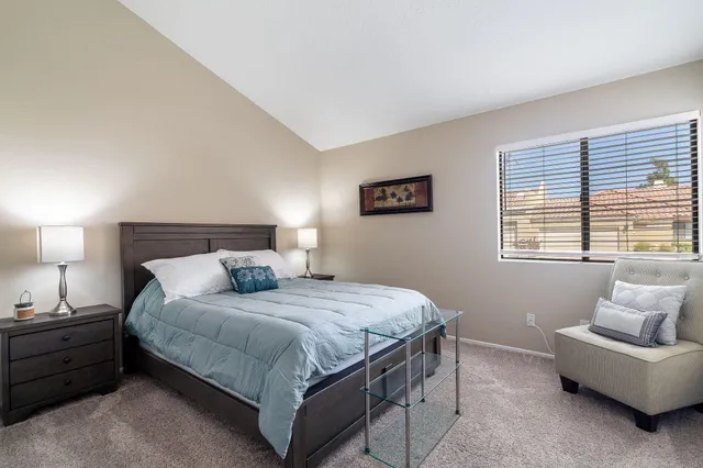 a bedroom with a bed and a couch