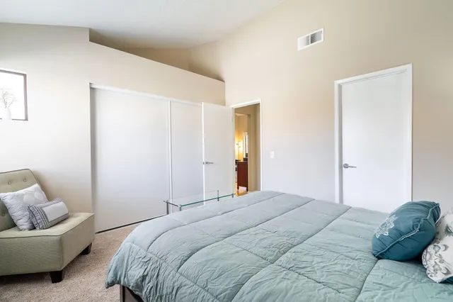 a bedroom with a bed and a couch