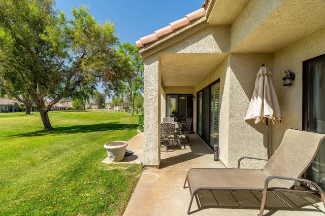 a view of a house with backyard porch and sitting area