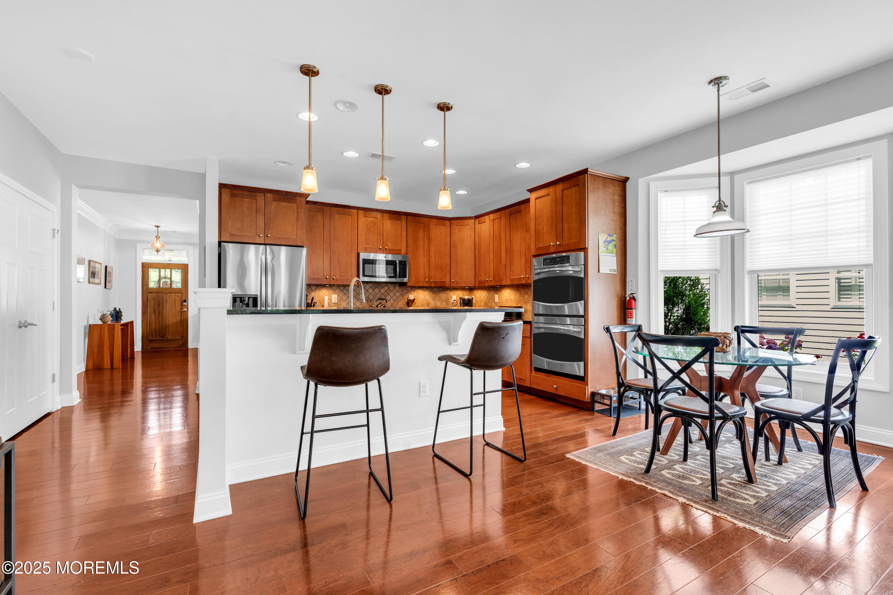 16 Haskell Way Oceanport, NJ 07757 - Photo 14 of 43 a open kitchen with stainless steel appliances kitchen island granite countertop a dining table chairs and white cabinets