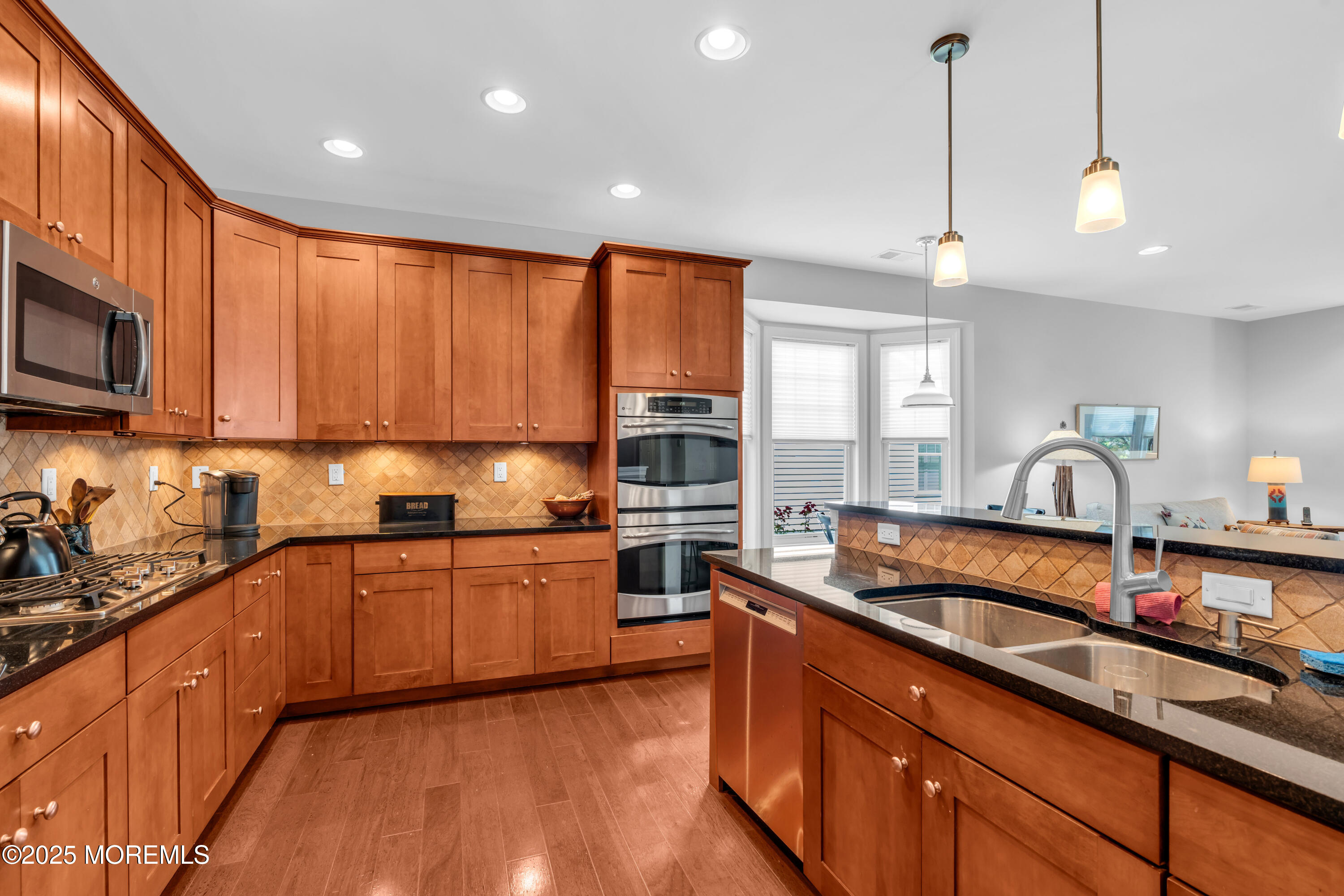16 Haskell Way Oceanport, NJ 07757 - Photo 15 of 43 a kitchen with stainless steel appliances granite countertop wooden cabinets a sink dishwasher a stove and a refrigerator with wooden floor