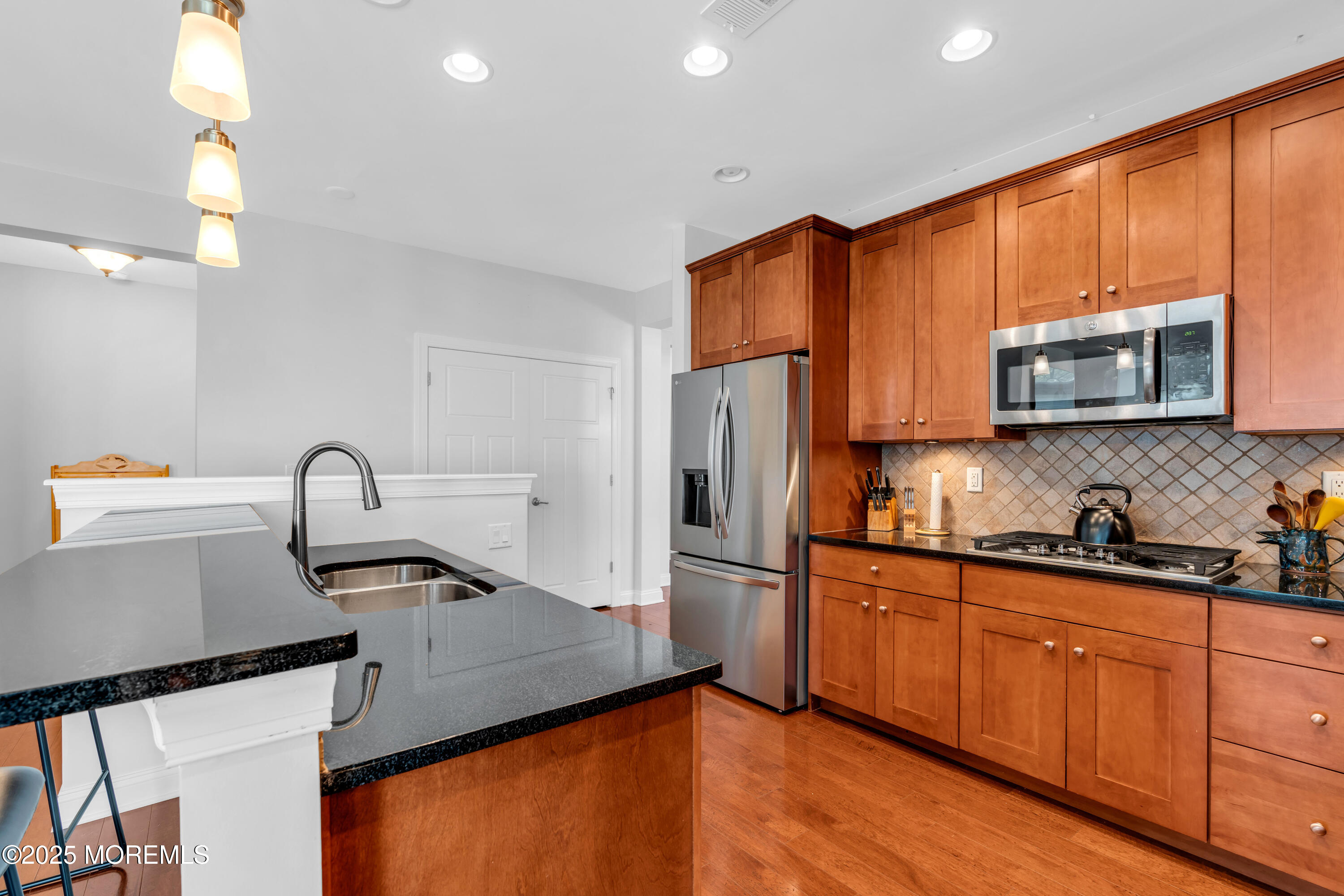 16 Haskell Way Oceanport, NJ 07757 - Photo 17 of 43 a kitchen with stainless steel appliances a sink dishwasher a refrigerator cabinets and wooden floor