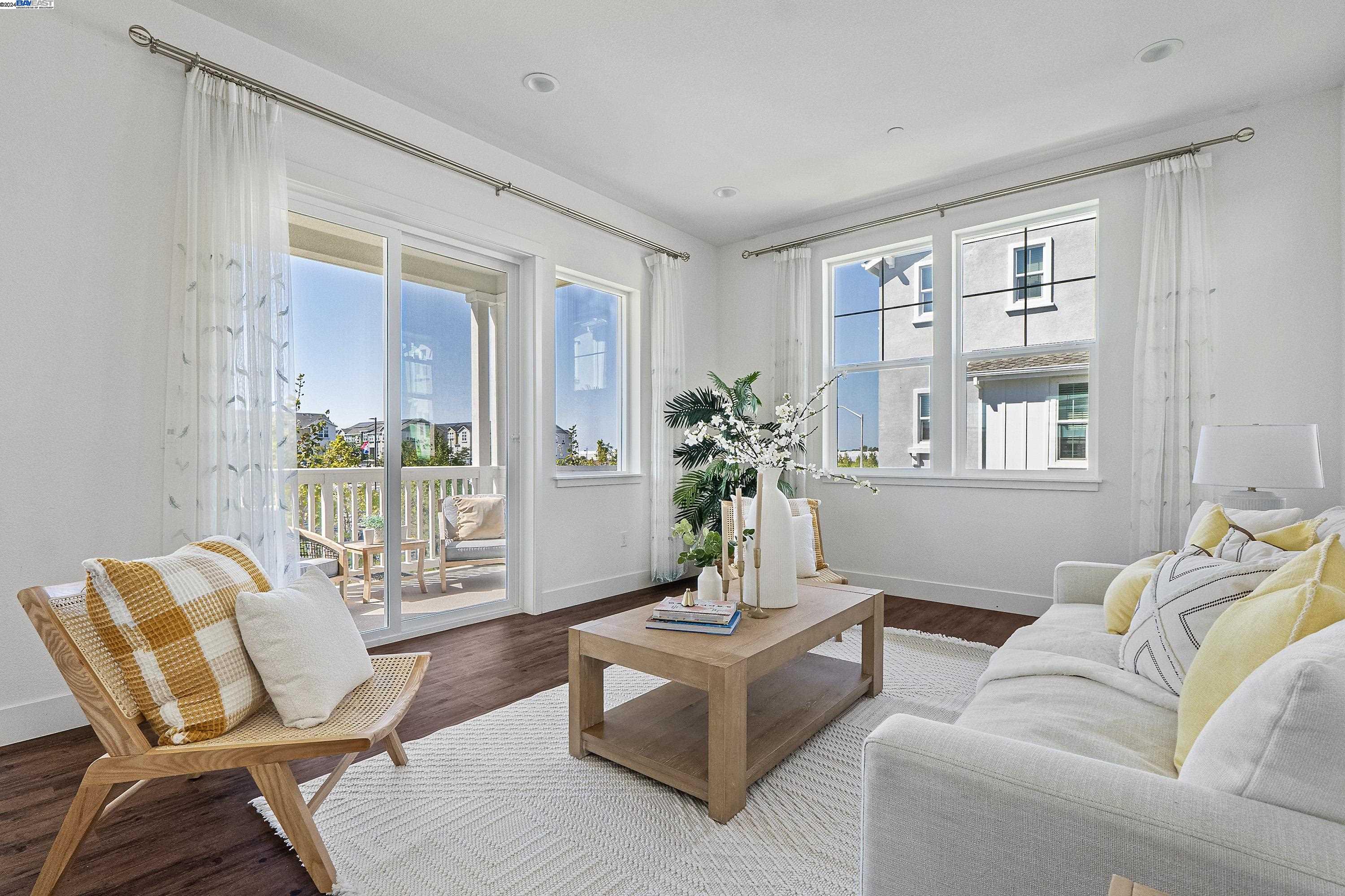 a living room with furniture and large windows