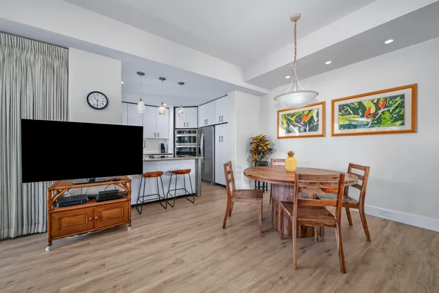 a view of a dining room with furniture and wooden floor