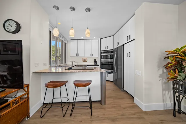 a kitchen with stainless steel appliances granite countertop a refrigerator and a stove