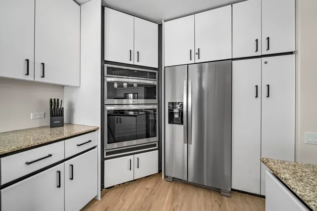 a kitchen with a sink cabinets and window