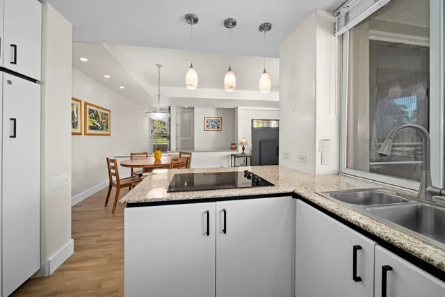 a view of a kitchen counter top space with stainless steel appliances granite countertop a sink and a cabinets