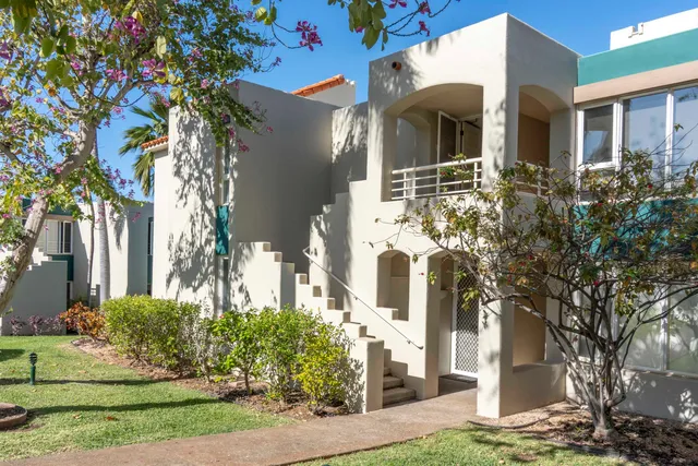 a dining room with furniture and a floor to ceiling window
