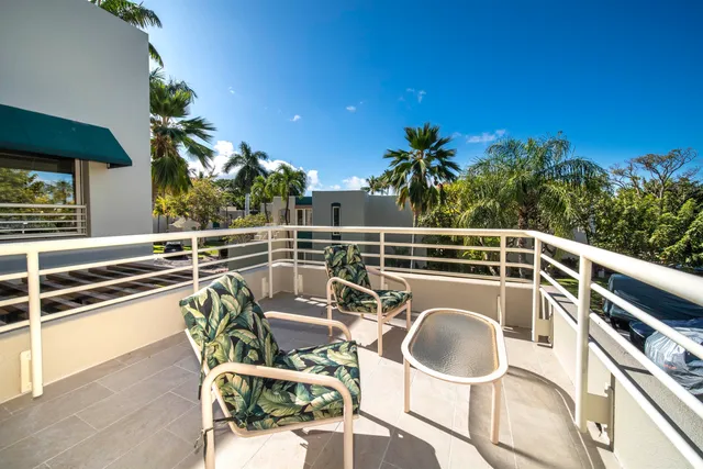 a front view of a house with swimming pool having outdoor seating