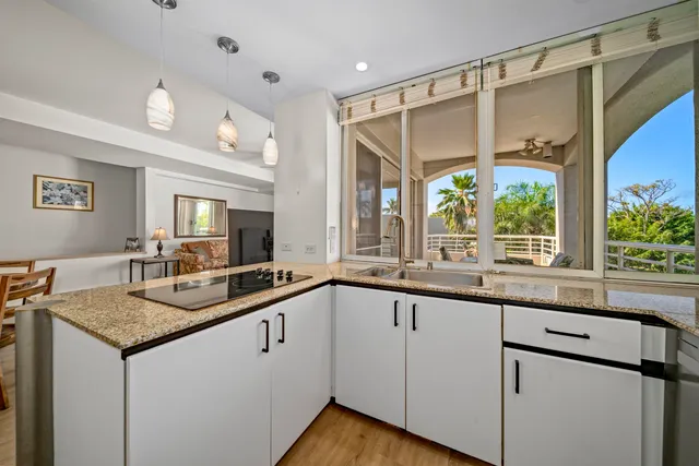 a kitchen with granite countertop a sink and cabinets