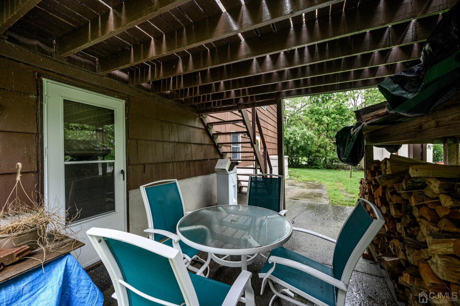 25 Sunset Drive Andover, NJ 07821 - Photo 34 of 43 a view of a chairs and table in patio with wooden floor