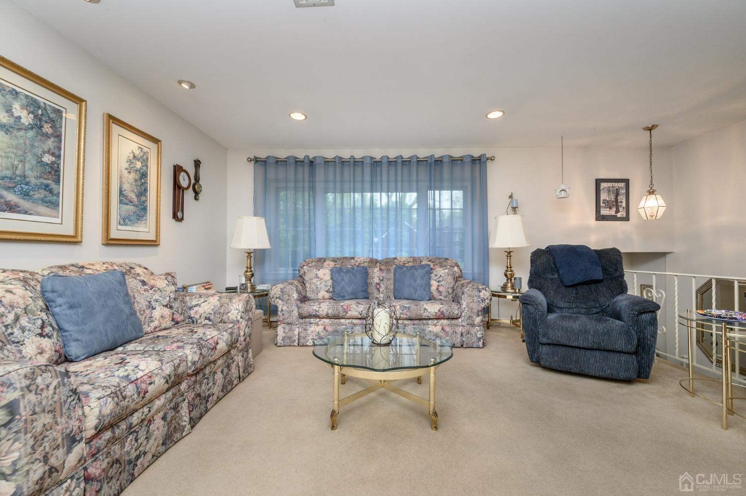 25 Sunset Drive Andover, NJ 07821 - Photo 4 of 43 a living room with furniture and a large window