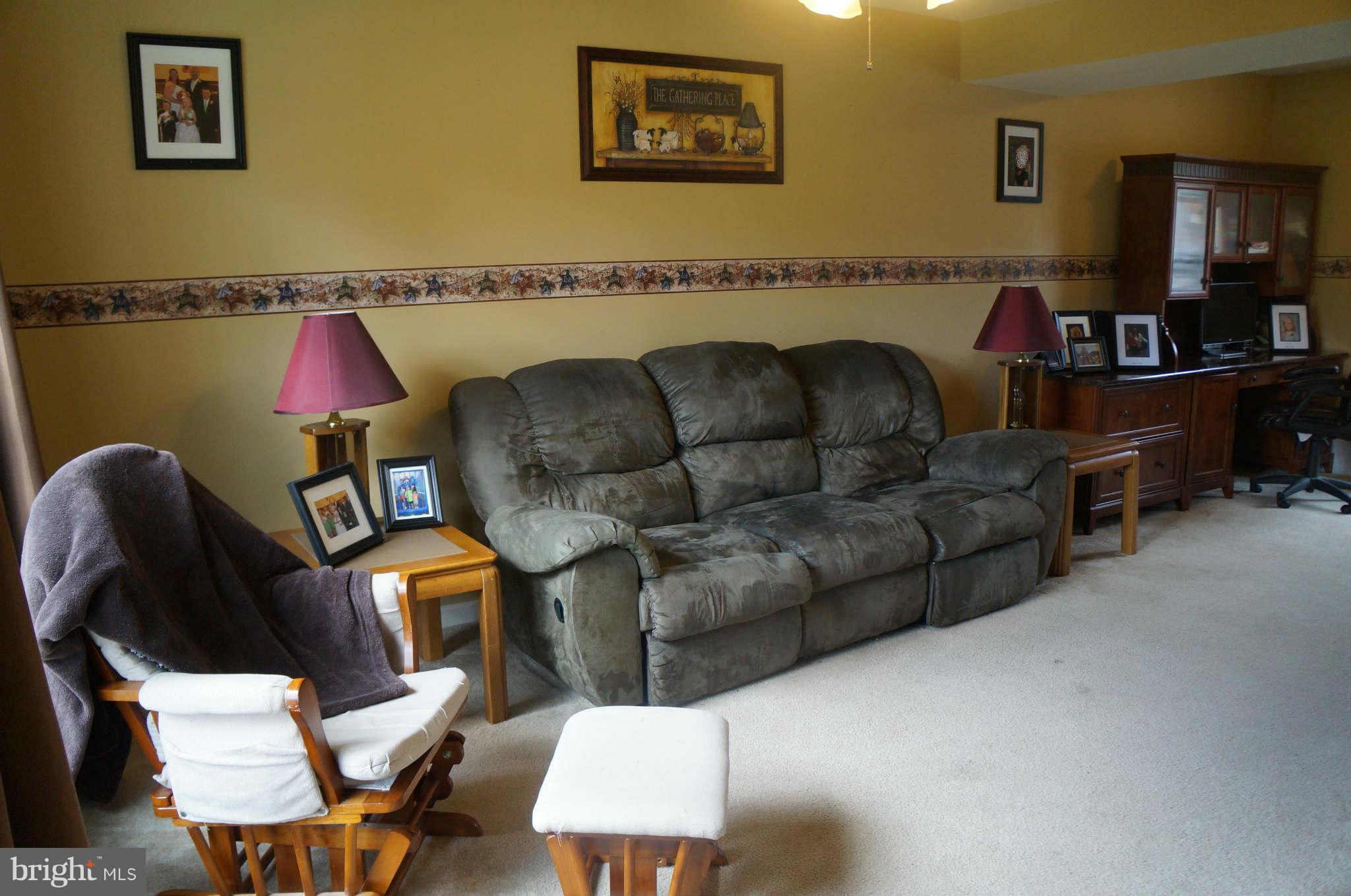 25252 Military Road Cascade, MD 21719 - Photo 3 of 26 a living room with furniture and a flat screen tv