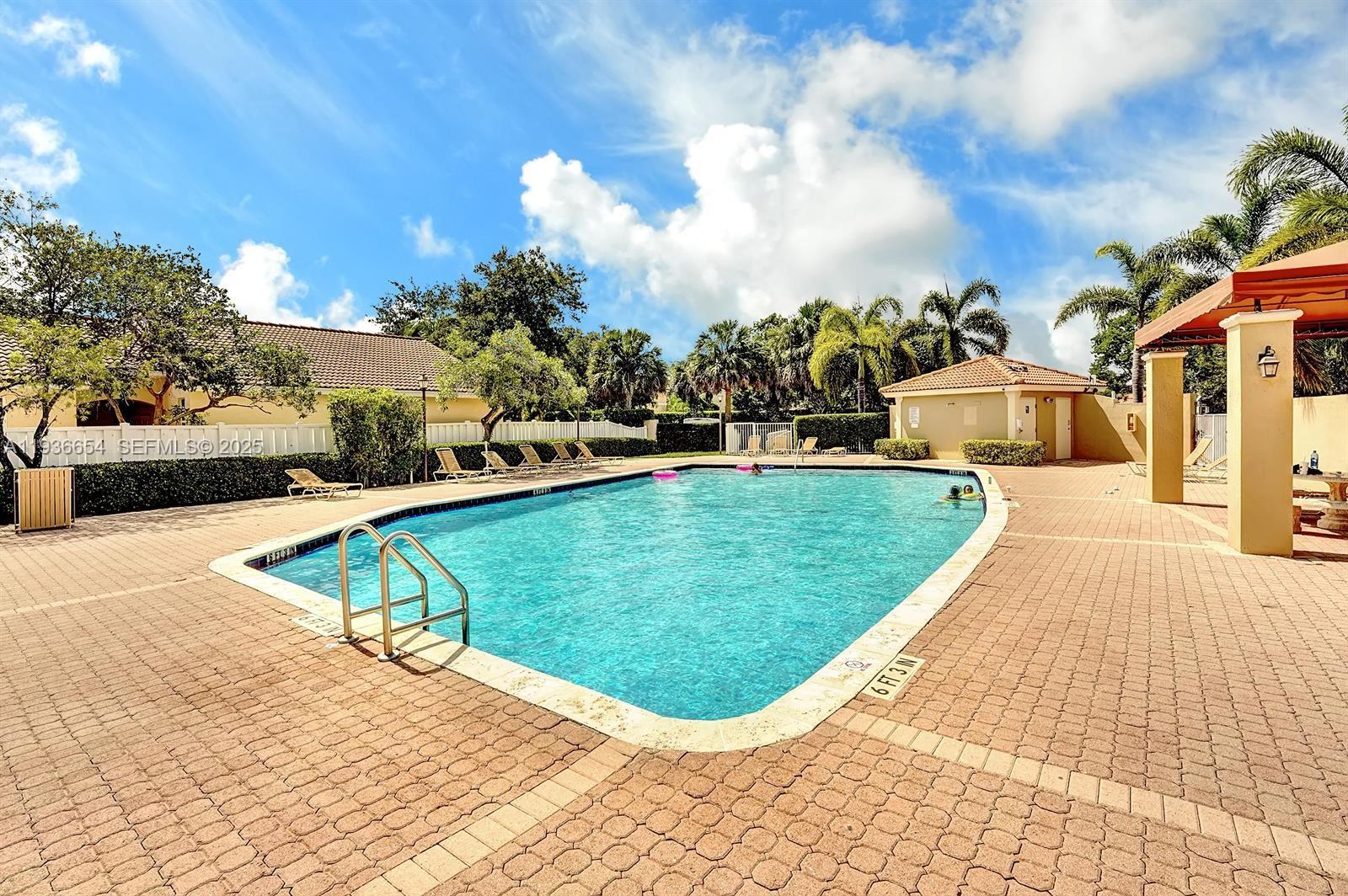 4908 Southwest 151st Avenue, Unit 1 Davie, FL 33331 - Photo 28 of 28 a view of a swimming pool with a yard