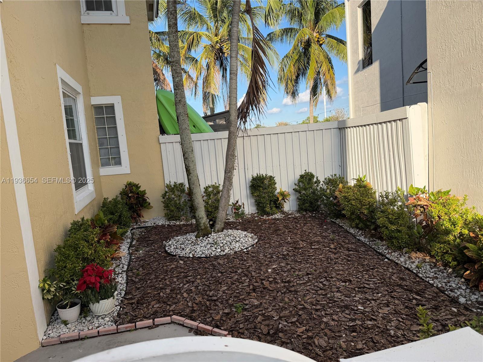 4908 Southwest 151st Avenue, Unit 1 Davie, FL 33331 - Photo 4 of 28 a view of a house with a small yard and plants