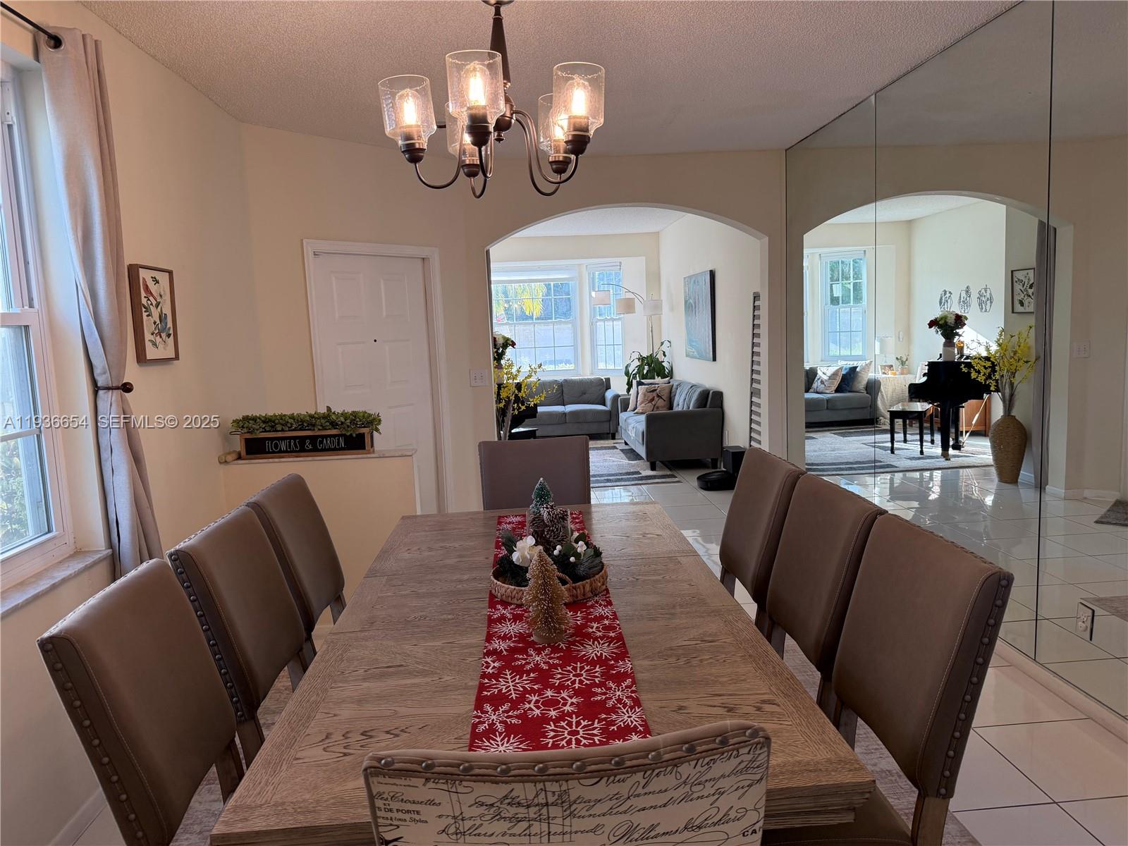 4908 Southwest 151st Avenue, Unit 1 Davie, FL 33331 - Photo 5 of 28 a living room with furniture and a chandelier