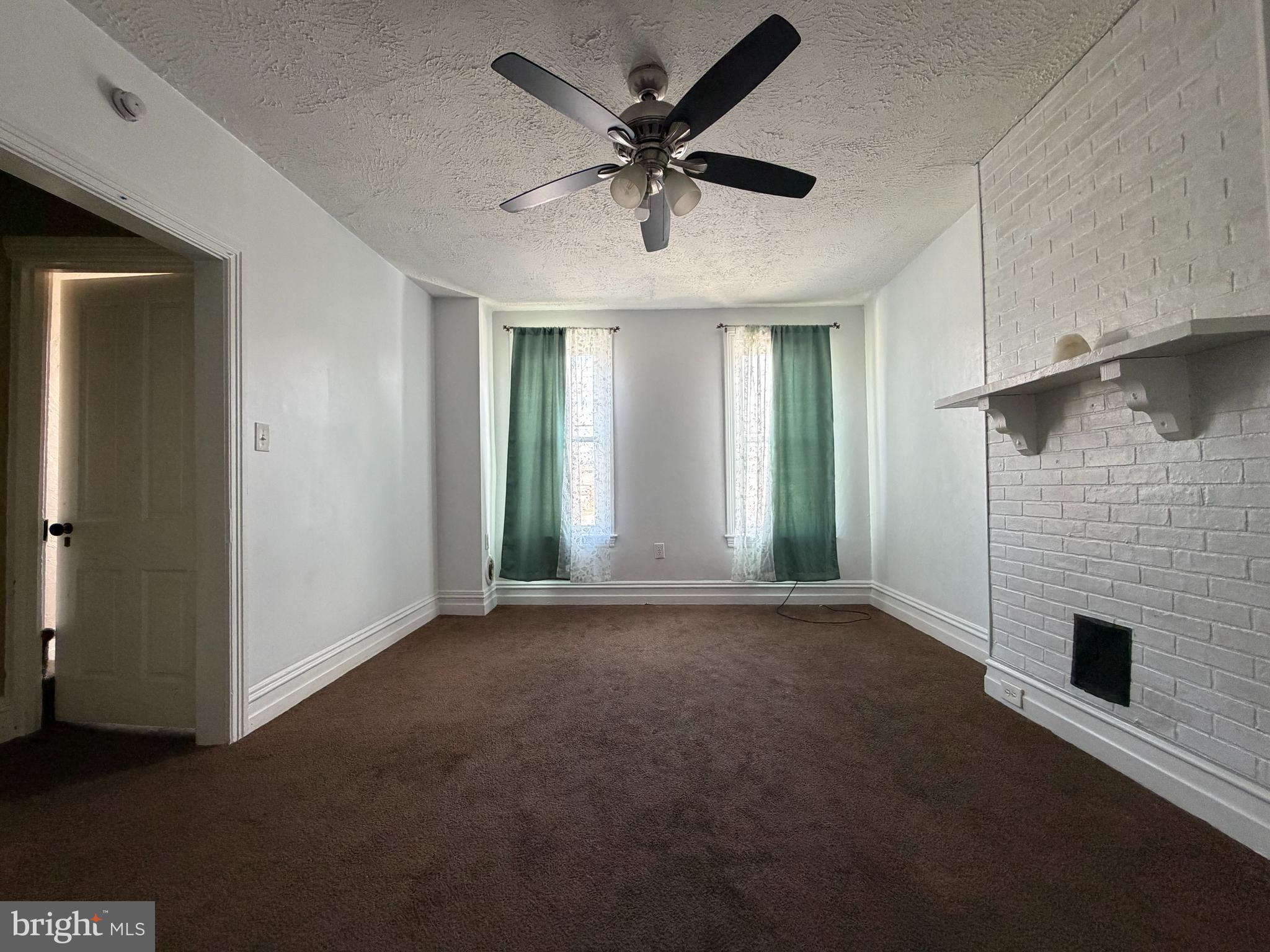 230 North 3rd Street Columbia, PA 17512 - Photo 11 of 15 an empty room with windows and ceiling fan