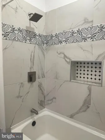 a bathroom with a bathtub and shower