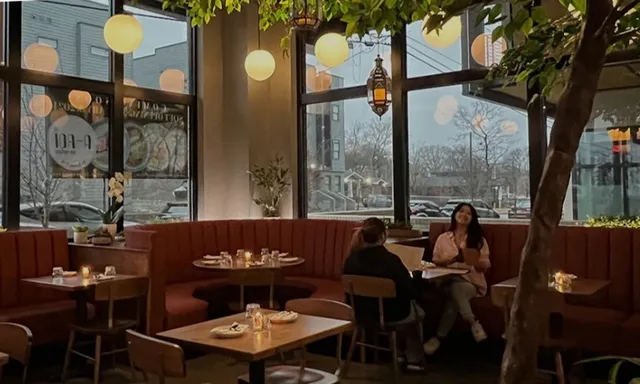 a view of a dining room with furniture and chandelier